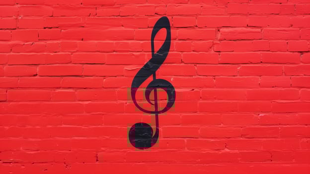 Red Brick Wall with Black Treble Clef Graffiti in Urban Street Art Mural Design photo