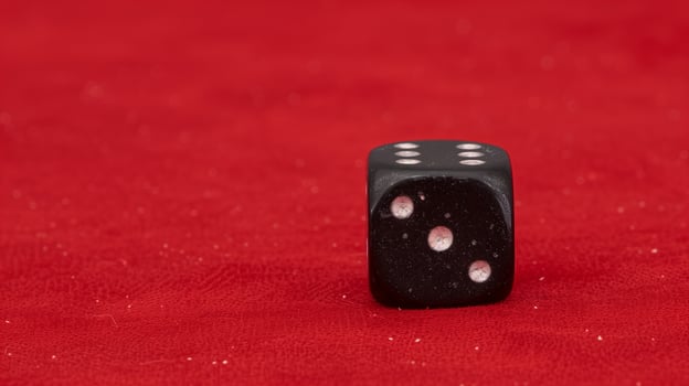 Black Dice with White Dots on Red Velvet Background - Gaming Chance Concept, Close-Up View, Luck Symbol photo