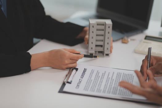 Sale representative offer house purchase contract to buy a house or apartment or discussing about loans and interest rates photo