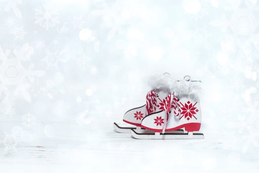 Christmas decoration. White skates with red ornament on a white background with snowflakes. photo