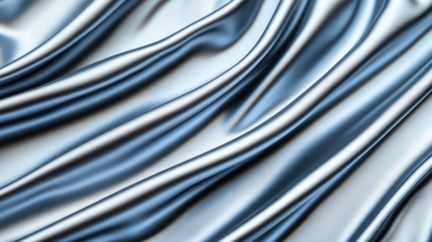 Silver silk fabric with smooth folds and icy blue highlights flowing softly elegant abstract background for winter holidays or New Years Eve cool and luxurious feel photo