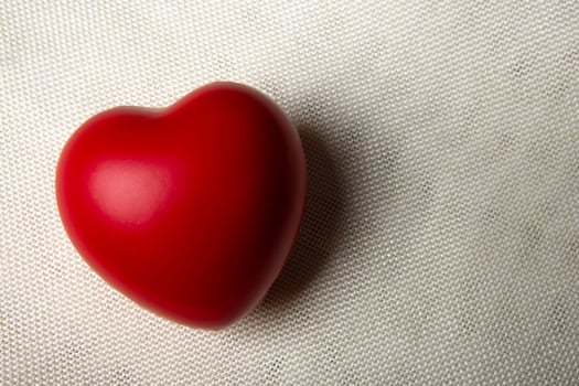 one large red heart on a textile background photo