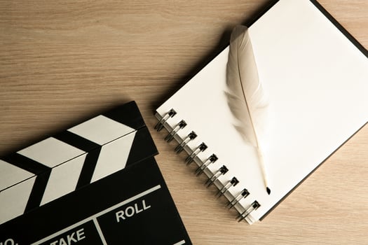 movie clapper and fountain pen on the diary photo