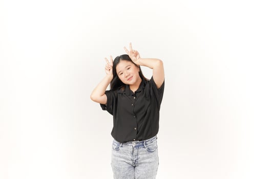 Young Asian woman showing peace sign two finger wearing Black t-shirt and jeans isolated on white background photo