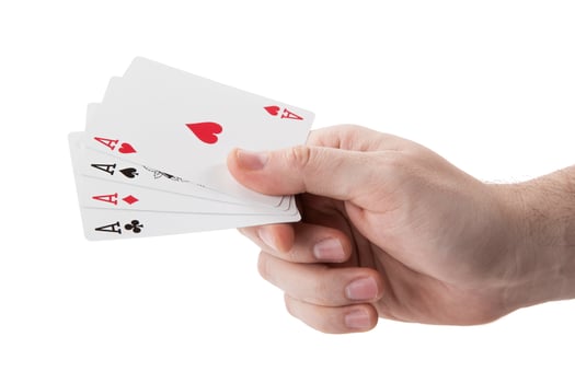 fan of playing card aces in hand on a white background photo