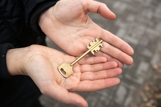 hand holds the key to an apartment in a new building photo