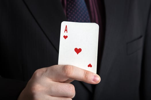 man holding a deck of cards and the ace of hearts photo