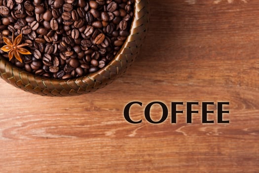 roasted coffee beans in a bamboo basket with title photo