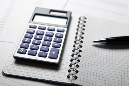 work on the calculator and papers photo