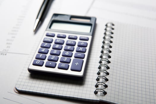 work on the calculator and papers photo