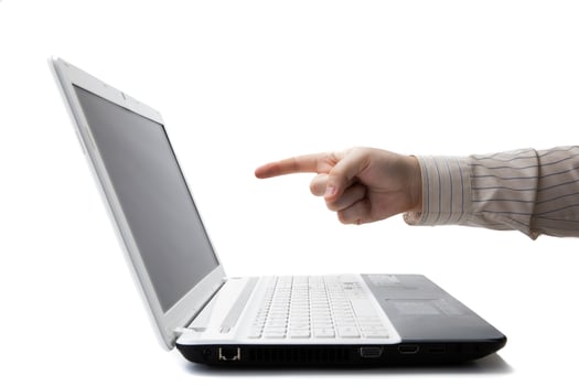 man's hand holding a finger on a laptop photo