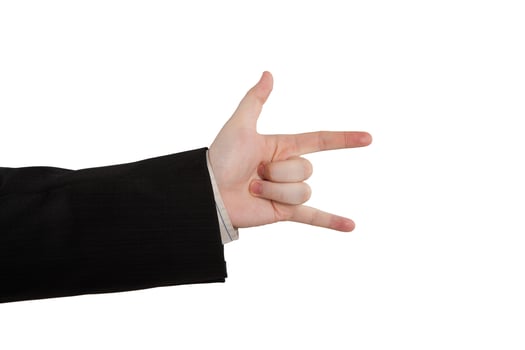 man's hand indicates horns photo