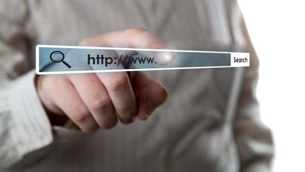 man's hand clicks on the address bar photo