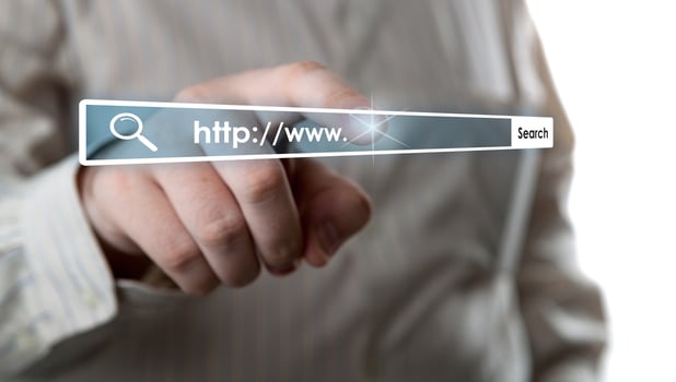 man's hand clicks on the address bar photo