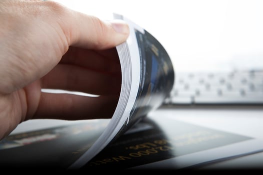 the hand through the pages of the magazine photo