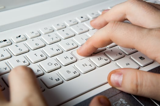 human fingers on the notebook keyboard photo