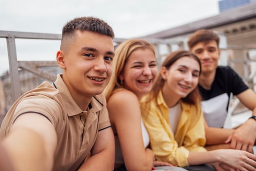 Four cute teenagers taking a selfie. Funny friends takes a picture of theyself photo