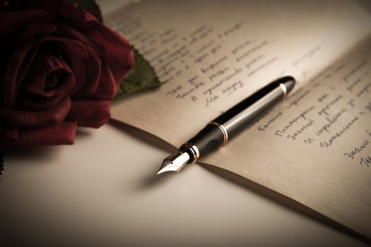 fountain pen on text sheet paper with rose photo