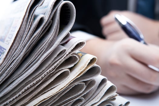 stack of newspapers in office close-up photo