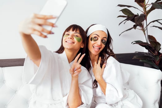 Mother and teen daughter have beauty day togather, making selfi photo