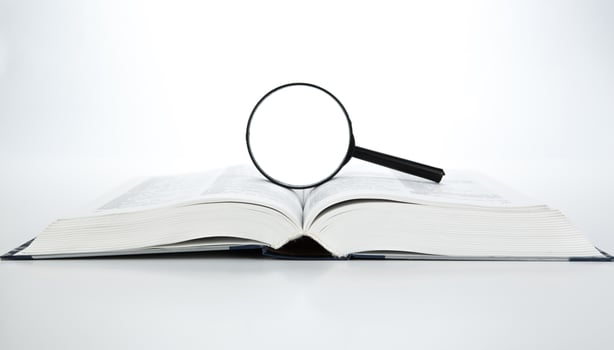 open book with loupe photo