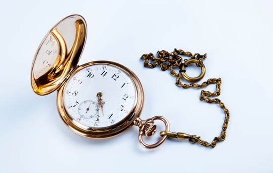 Gold pocket watch on white photo