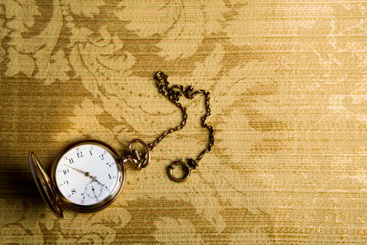 Gold pocket watch on gold cloth photo