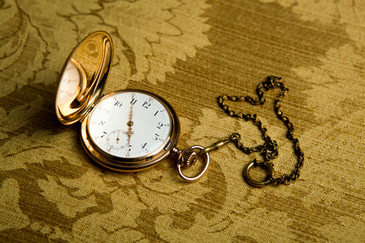 Gold pocket watch on gold cloth photo