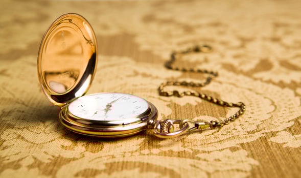 Gold pocket watch on gold tablecloth photo