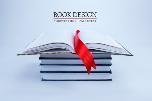 open book on a pile of books photo