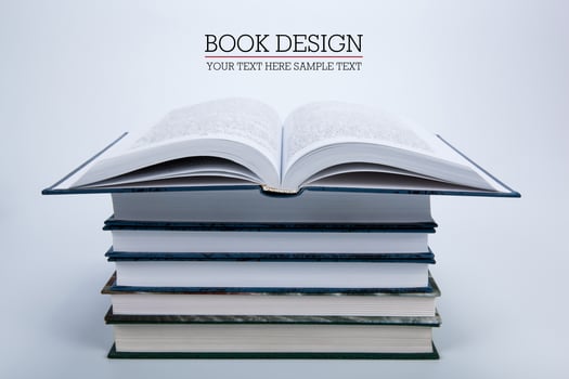 open book on a pile of books photo