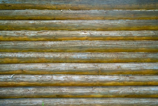Old wooden logs wall of the house. Vintage wood texture. photo