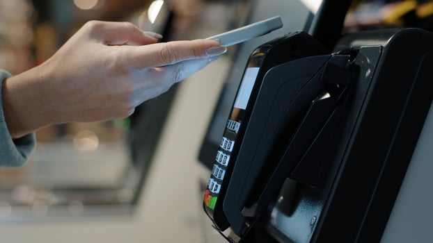 Details female hands paying with phone purchase by cell-phone electronic payment machine card reader e-money concept. Woman client pay smartphone. Pos-terminal buy cashless wifi qr code nfc scan app photo