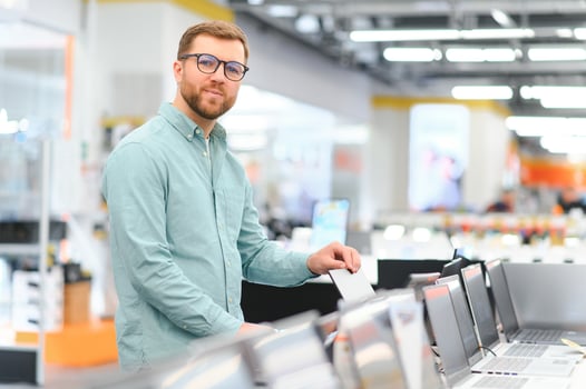 Client choosing laptop in store photo