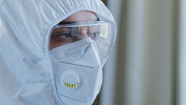Portrait of tired stressed Arabic spanish doctor man male face and eyes in safety glasses and protective mask special medical uniform looking at camera. Laboratory worker Coronavirus COVID-19 pandemic photo