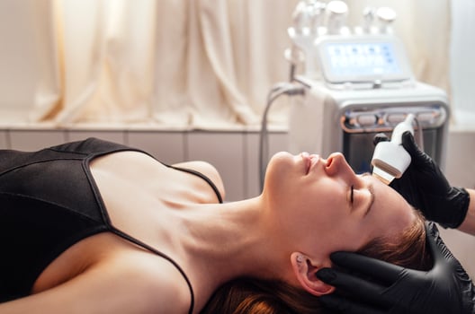 a woman getting a facial treatment photo