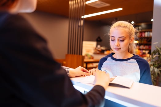 Smiling female client communicates with reception woman in a beauty salon photo