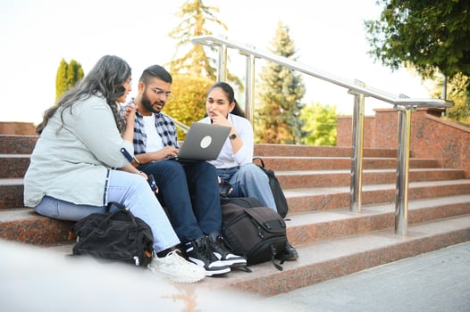 group of young students checking exam results or waiting for project approval on laptop at collage campus photo