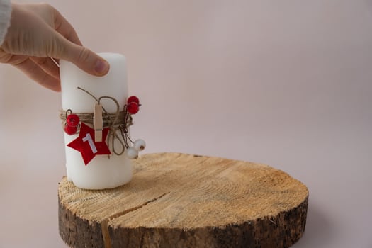 Step by step instruction of making handmade Christmas advent four weeks candle calendar. Female hands creating craft homemade decor. New year celebration. Winter holidays. Do it yourself photo
