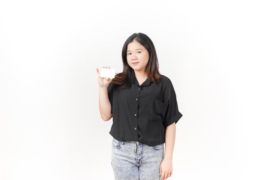 Young Asian woman presenting and showing blank card wearing Black t-shirt and jeans isolated on white background photo