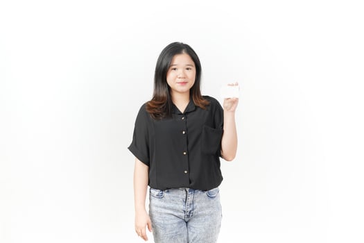 Young Asian woman presenting and showing blank card wearing Black t-shirt and jeans isolated on white background photo