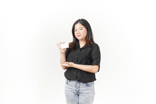 Young Asian woman presenting and showing blank card wearing Black t-shirt and jeans isolated on white background photo