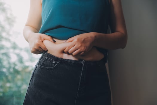 fat woman, fat belly, chubby, obese woman hand holding excessive belly fat with measure tape, woman diet lifestyle concept photo