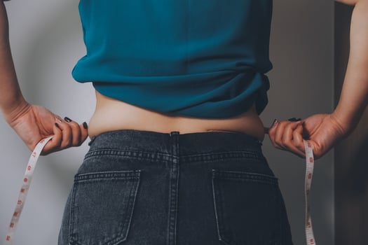 fat woman, fat belly, chubby, obese woman hand holding excessive belly fat with measure tape, woman diet lifestyle concept photo