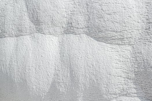 Stone texture covered with calcium deposits. Pamukale texture. Light back. photo