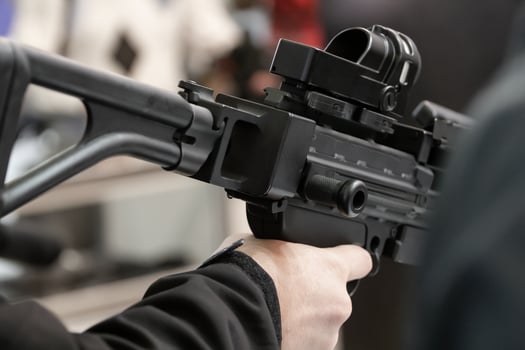 Mens choose guns on stands with weapons. Weapon stand at an arms exhibition. photo