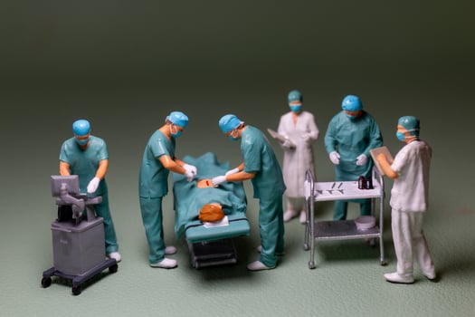 Miniature people, medical personnel surgery scene in progress, typical of an operating room environment. photo