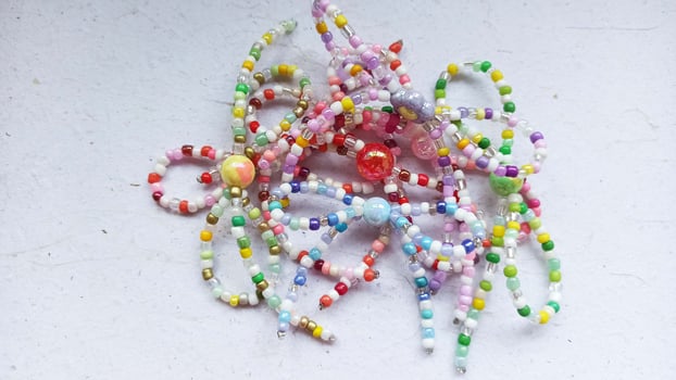a bunch of beads are on a table and handmade ribbon from bead photo