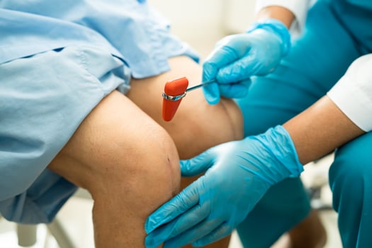 Asian doctor inject Hyaluronic acid platelet rich plasma into the knee of senior woman to walk without pain. photo