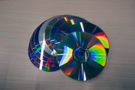 Stack of compact disks on a wooden table. Vcd, blueray photo